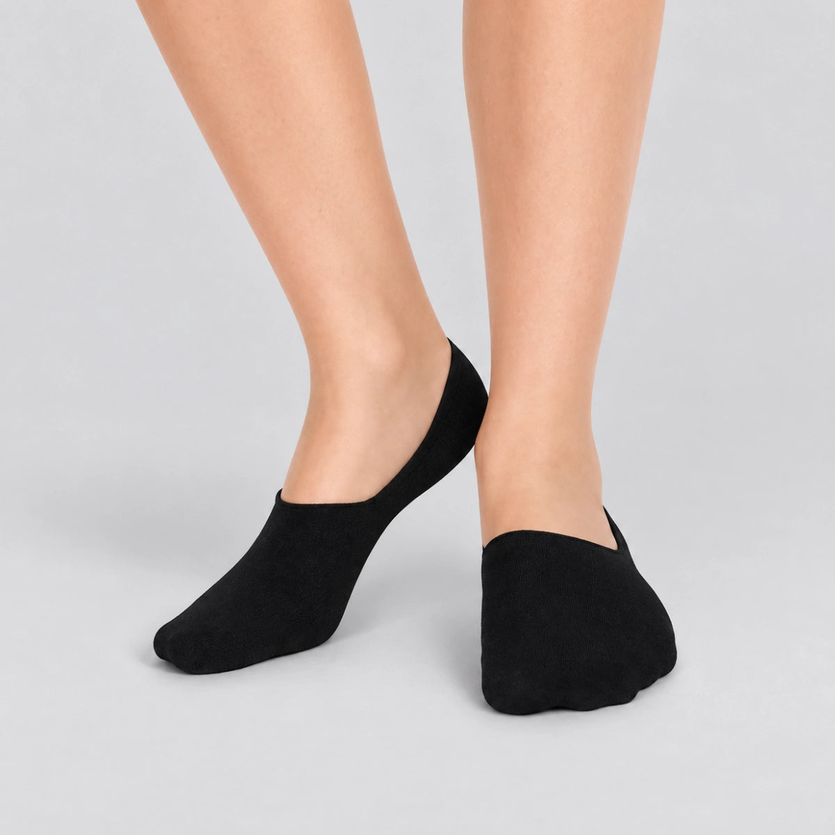 Person wearing charcoal no-show socks  on a white background