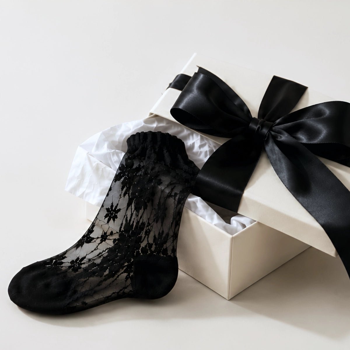 Gift box with black ribbon and black lace sock