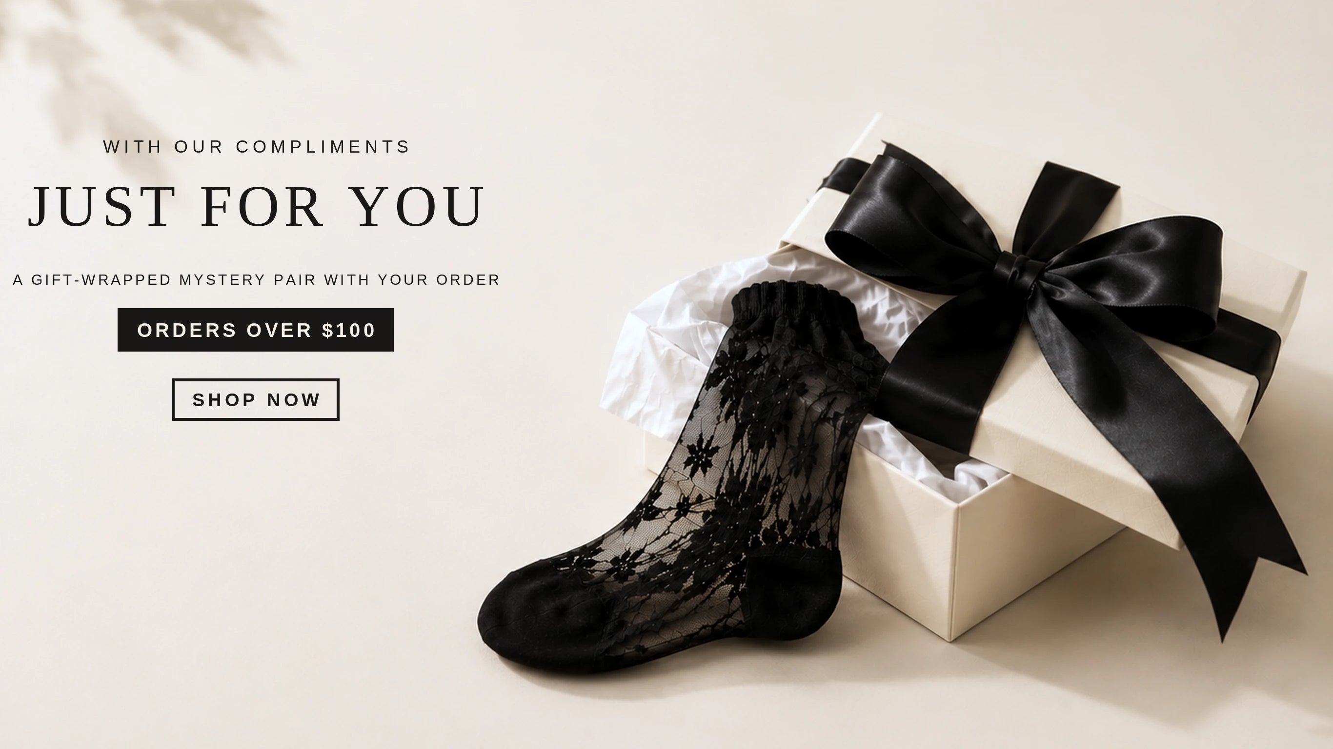 Complimentary mystery pair with orders over $100 – Uniq Socks gift box with black ribbon and lace sock