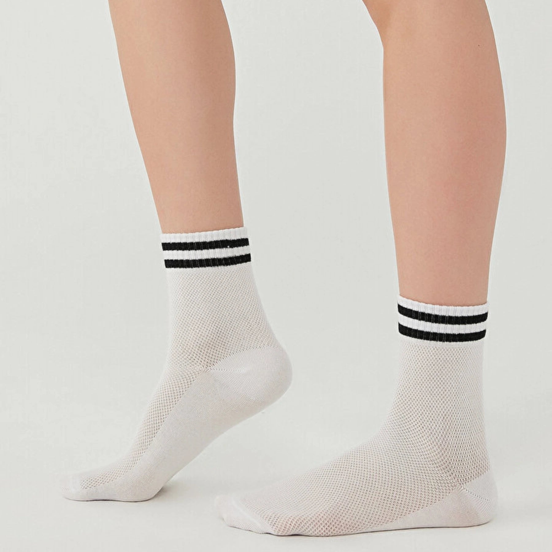 White socks with breathable mesh design, quarter length with black stripes