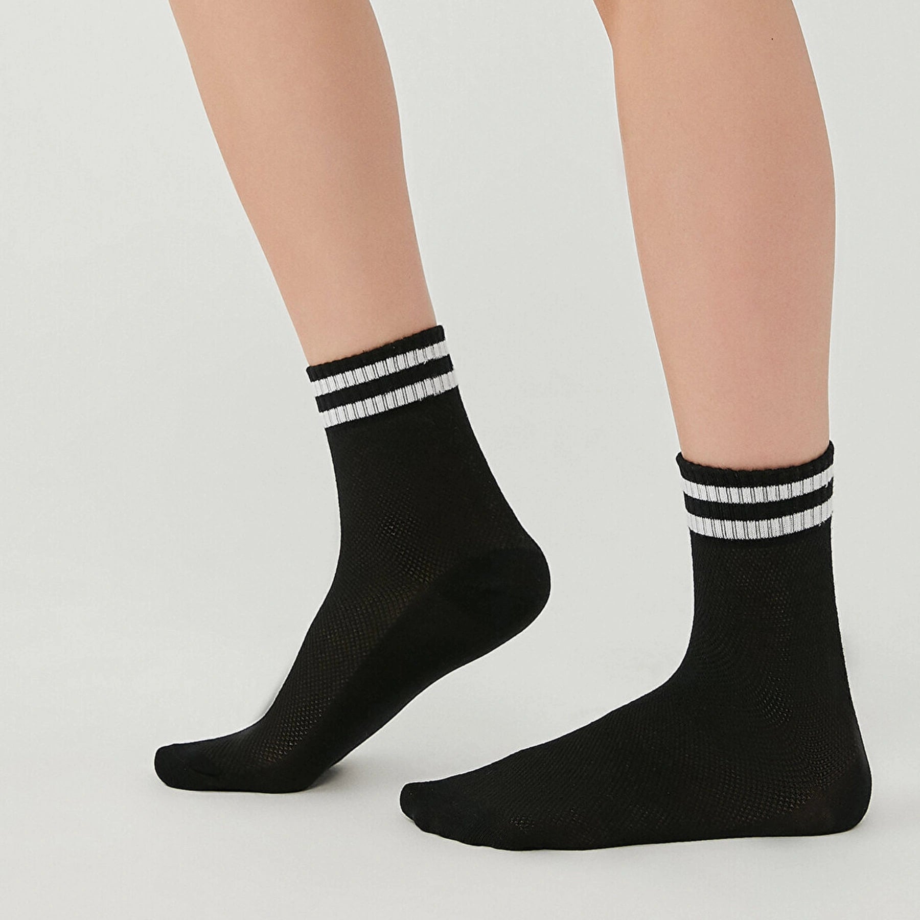 Black socks with breathable mesh design, quarter length with white stripes