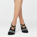 image of woman wearing black and stripe yoga socks