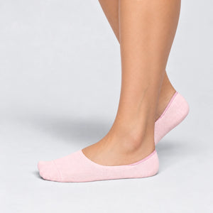 Person wearing seamless pink bamboo no-show socks on a white background