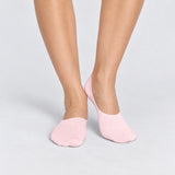 Person wearing seamless pink bamboo no-show socks on a white background