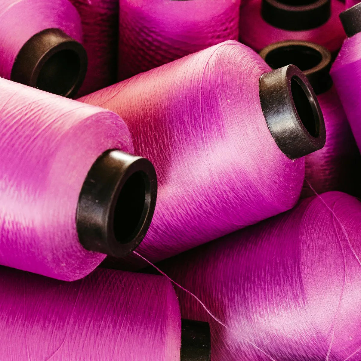 Close-up of pink spools of yarn