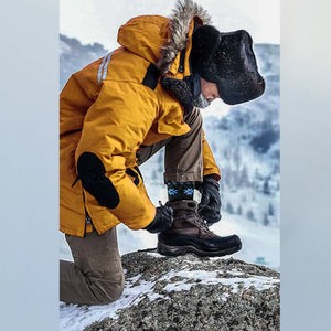 A man in snow gear wearing charcoal, Nordic patterned alpaca and merino wool socks