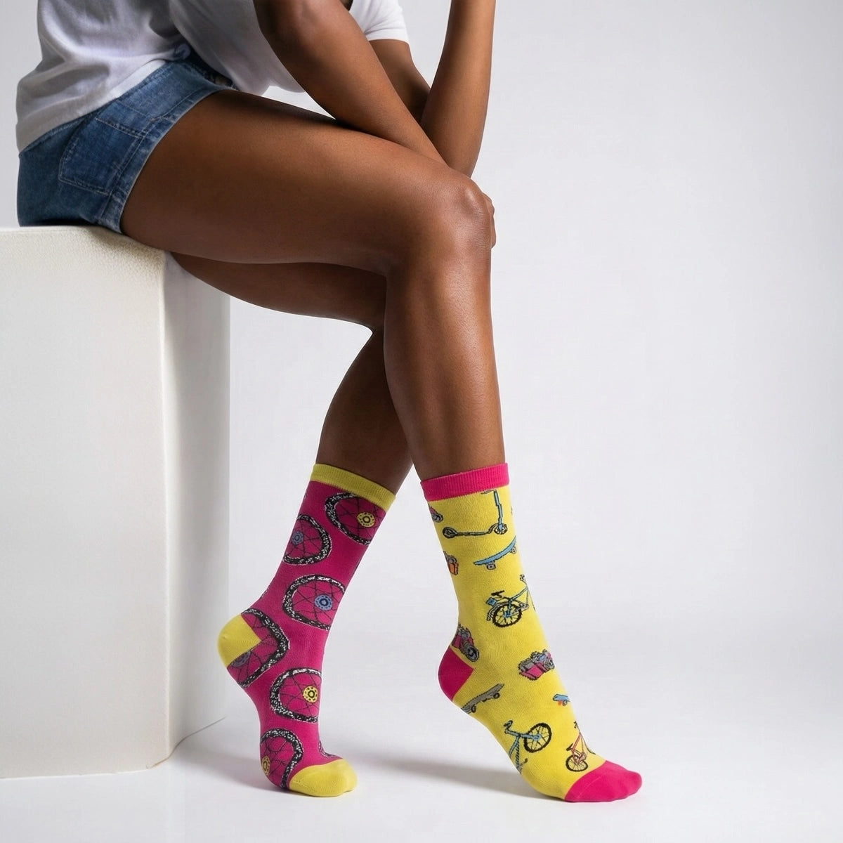 Person wearing bicycle themed socks with a white background