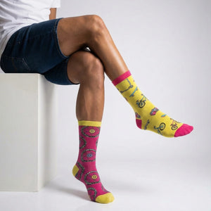 Person wearing bicycle themed socks with a white background