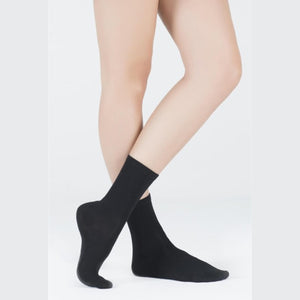 image of woman wearing black crew socks