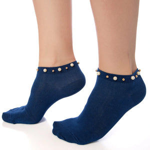 A woman wearing blue ankle socks embellished with pearls around the cuff