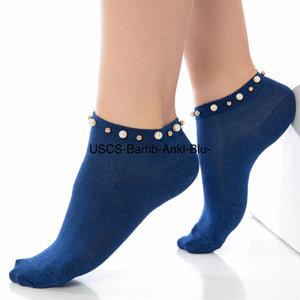 A woman wearing blue ankle socks embellished with pearls around the cuff