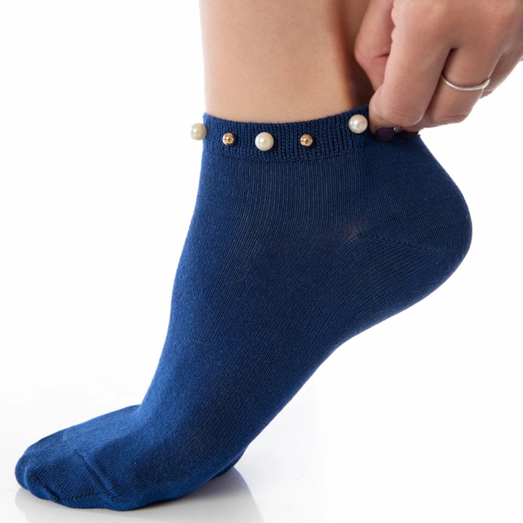 A woman wearing blue ankle socks embellished with pearls around the cuff