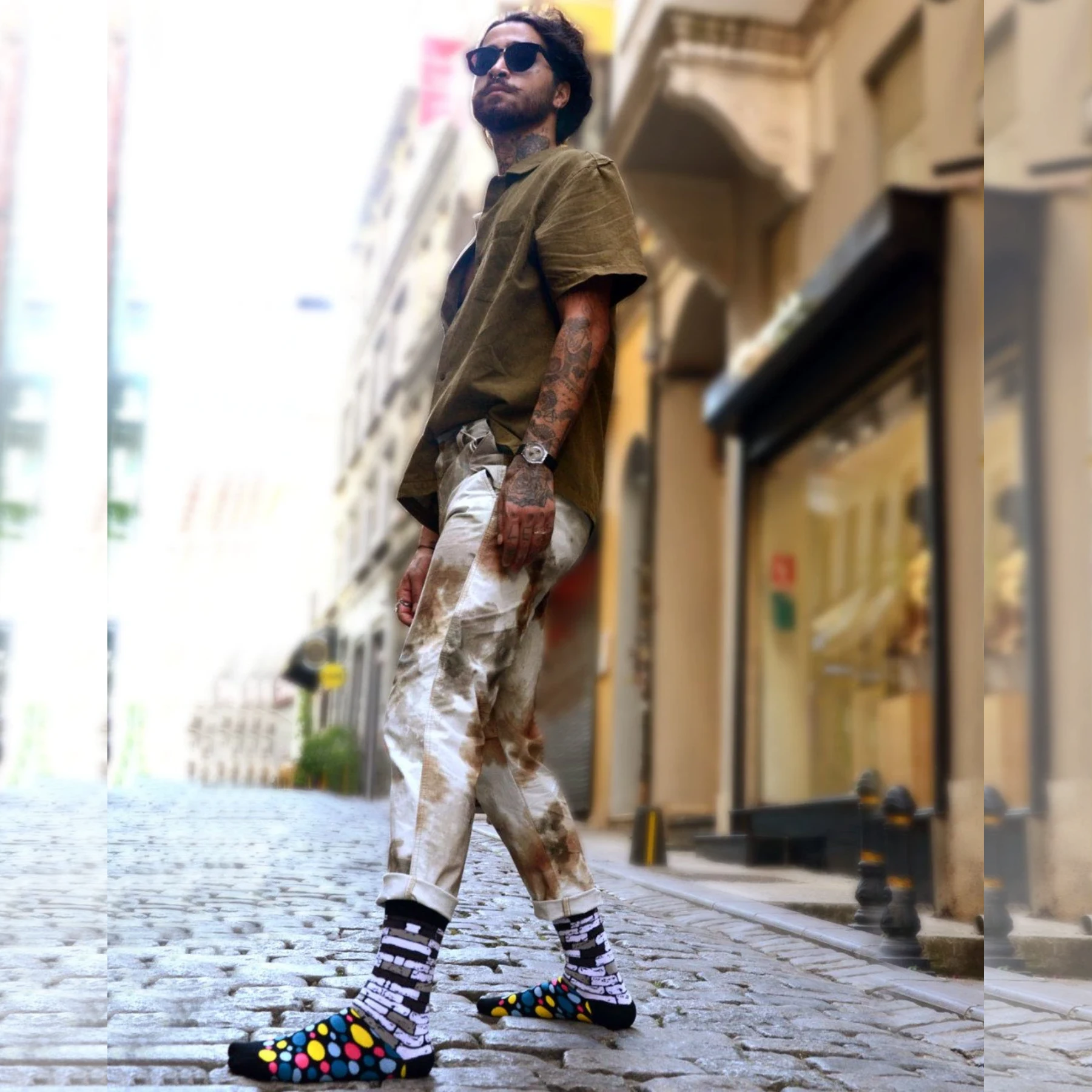 image of man wearing bricks and dot patterned colourful socks