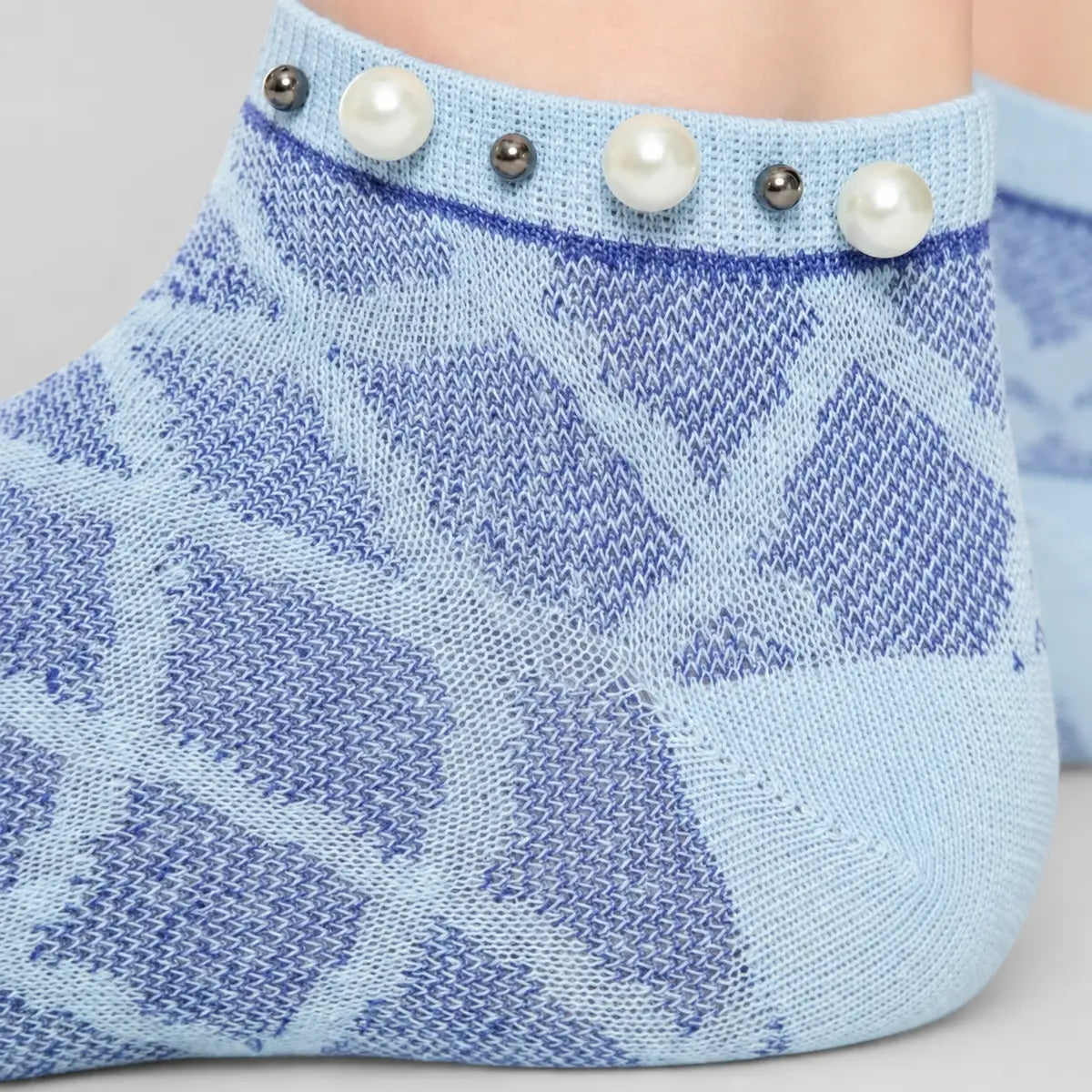 A woman wearing blue checked ankle socks finished with pearls around the cuff
