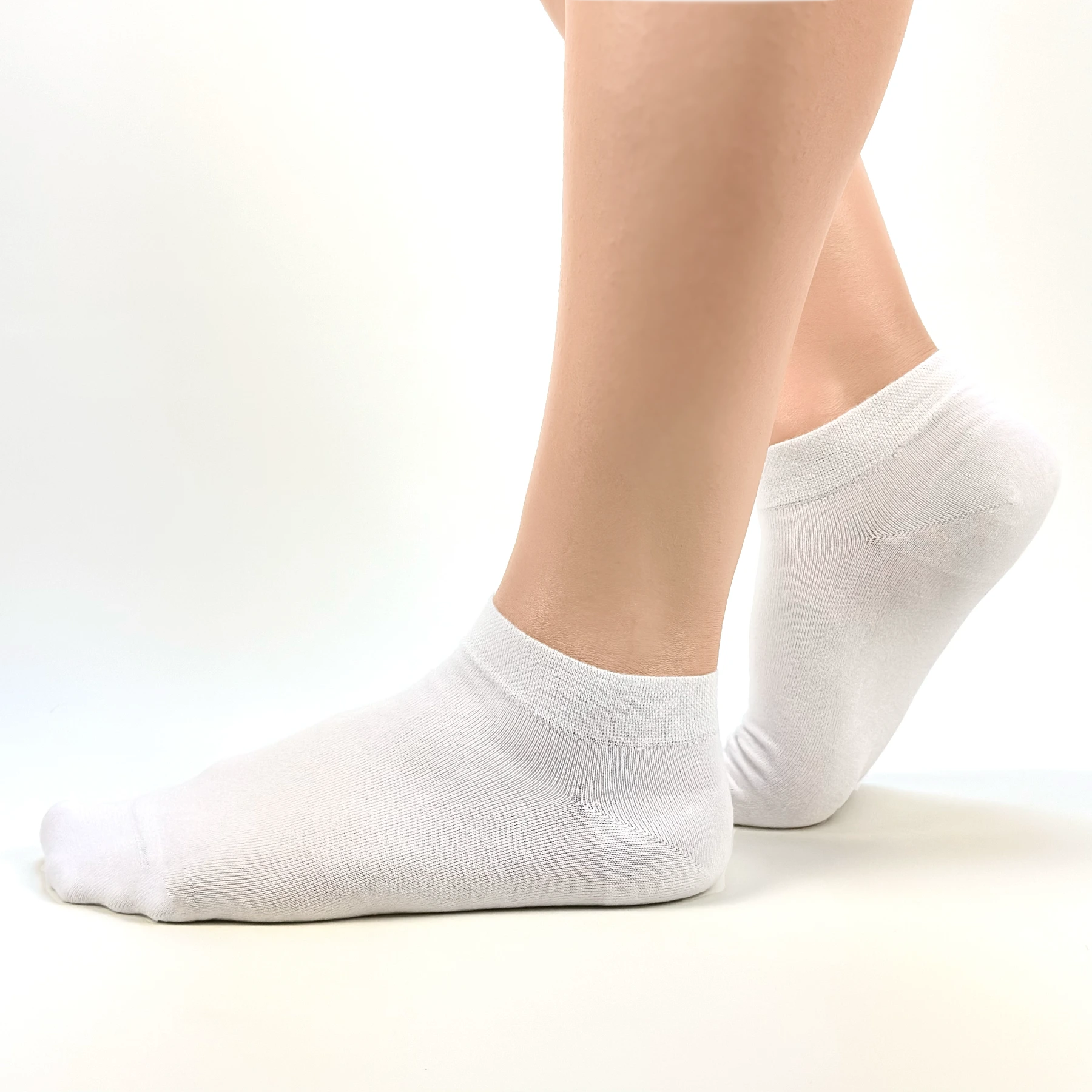 Close image of person wearing white bamboo ankle socks