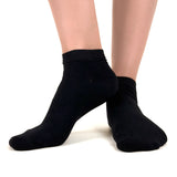 Close image of person wearing black bamboo ankle socks