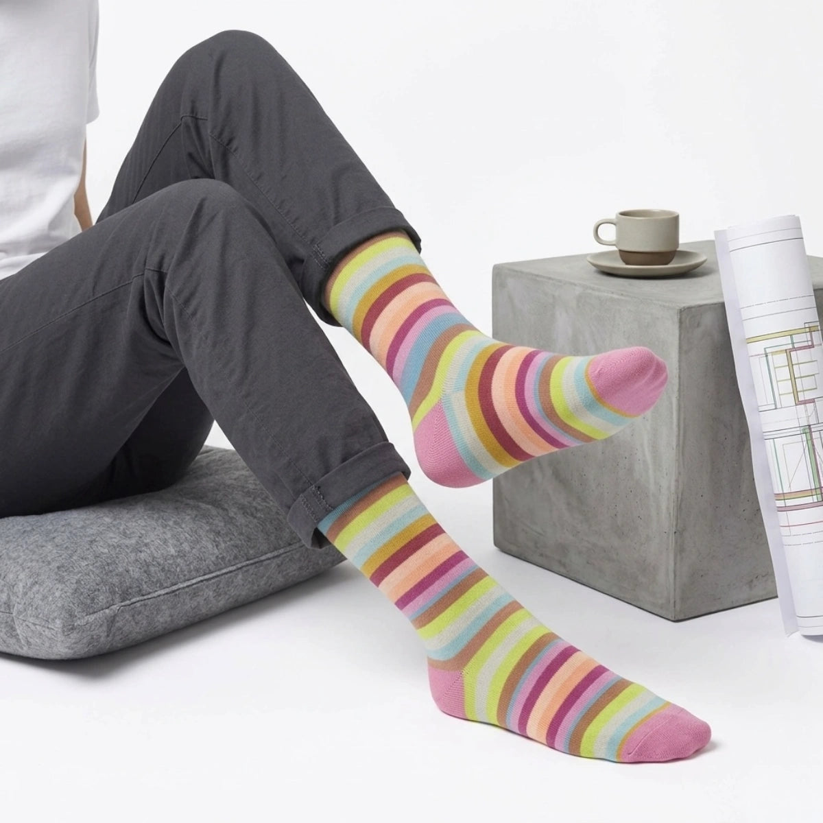 Person wearing colorful striped socks on a light background