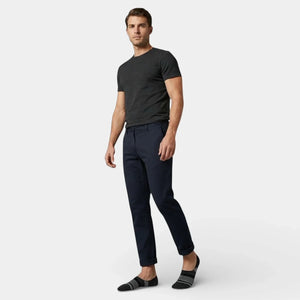 Man wearing grey striped no-show socks standing against a white background