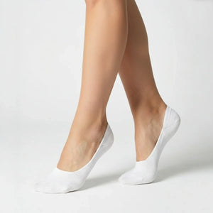 Woman wearing white no-show socks on light grey background