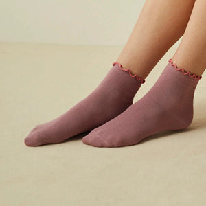 Chic and cozy rose ruffle socks for a stylish finishing touch.