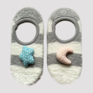 Mismatched grey and white striped loungewear socks with a cute star and moon applied