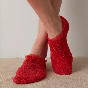 image of woman wearing red house socks