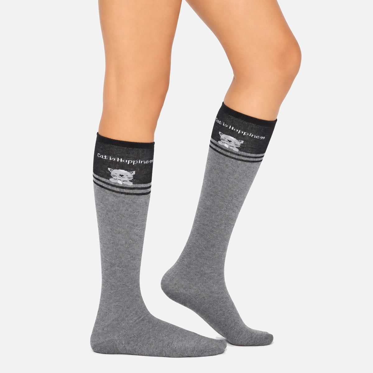 A pair of grey knee high socks with a cat design.