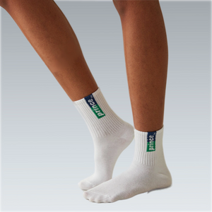 person wearing white tennis socks with blue and green Prince label