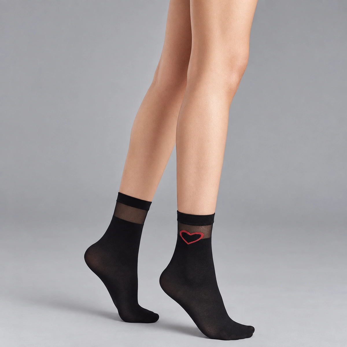 person wearing sheer black crew socks with striped cuff and loveheart detail