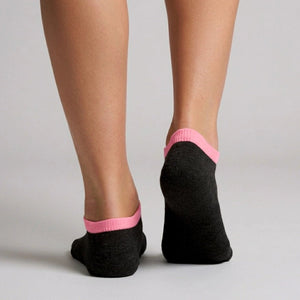 Person wearing black seamless ankle socks with pink cuff against a neutral background