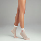 person wearing white sheer quarter length socks stating 'femme'