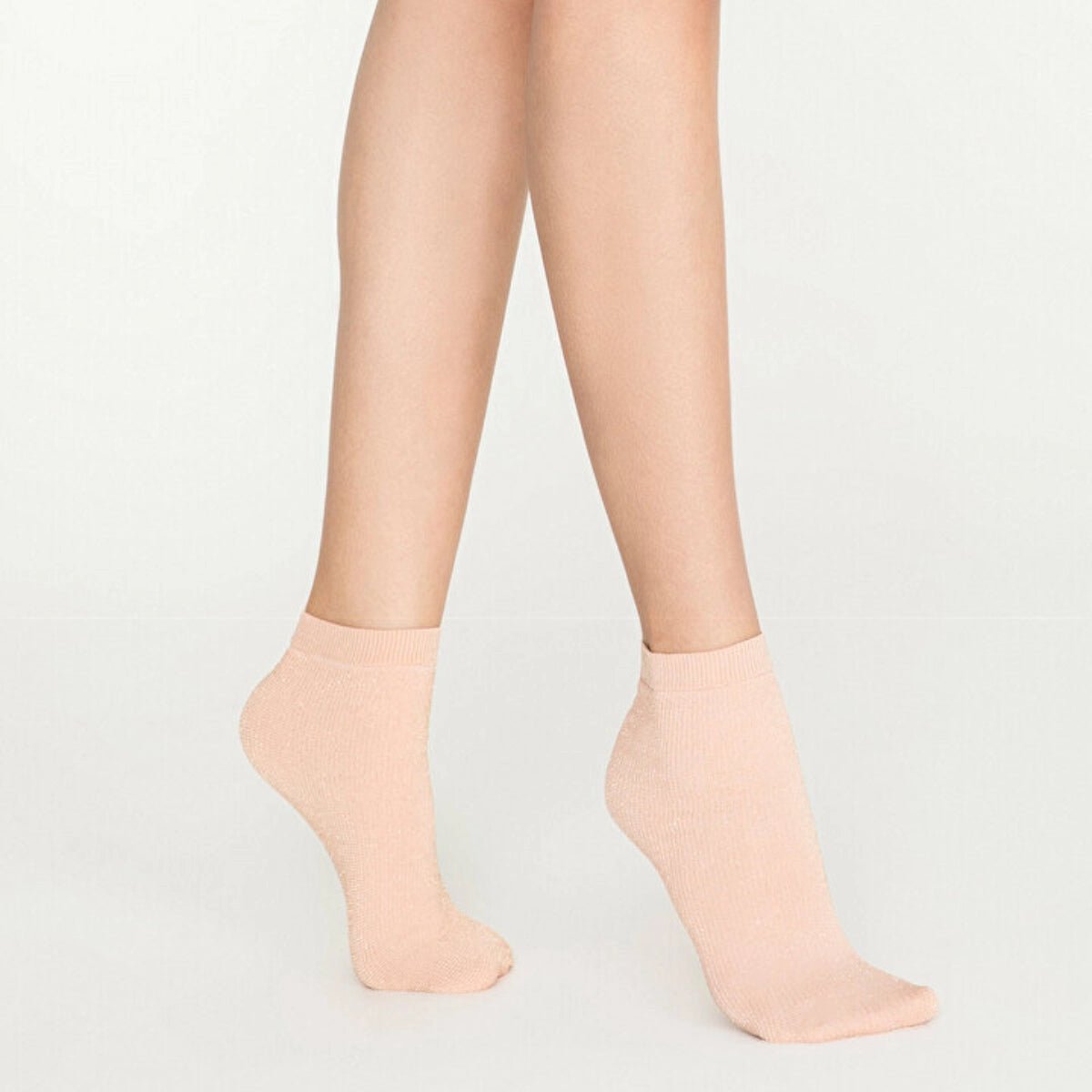 Woman wearing pink, sparkly ankle sock