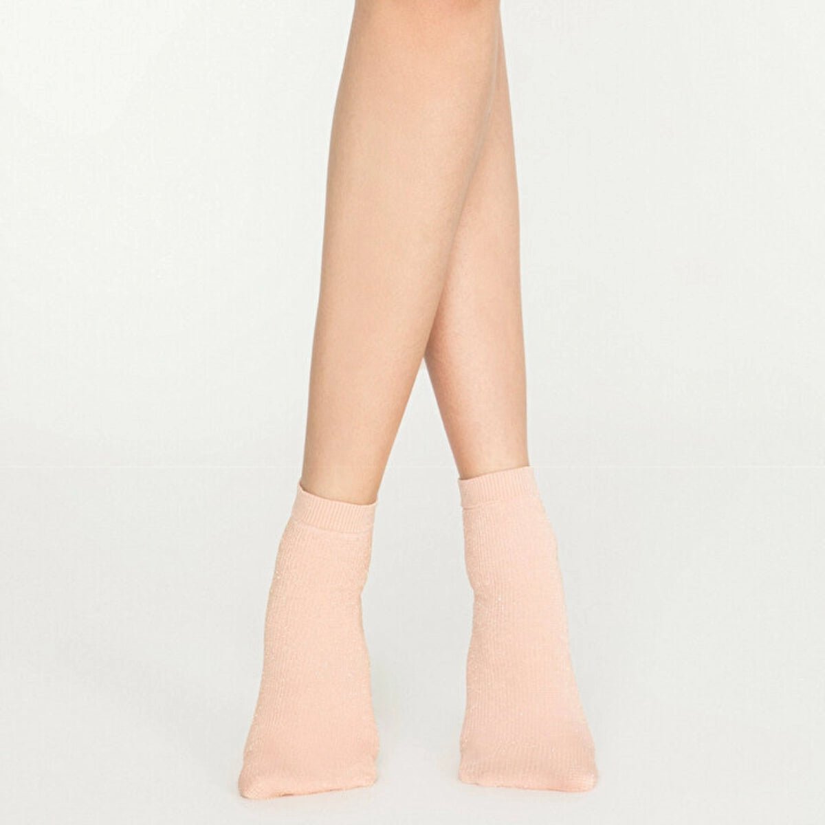 Woman wearing pink, sparkly ankle sock