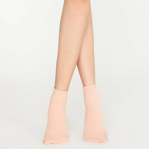Woman wearing pink, sparkly ankle sock