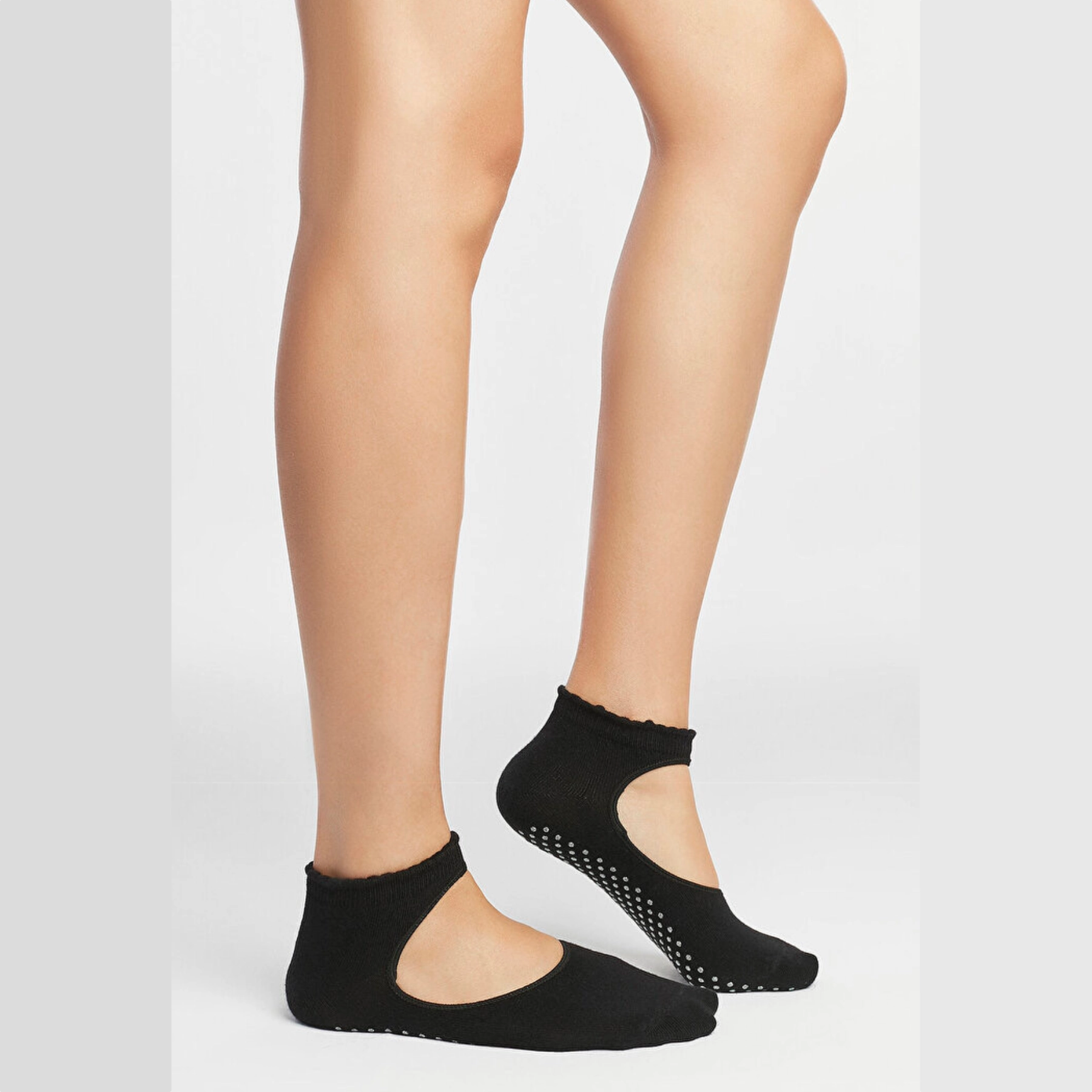 image of woman wearing black yoga socks