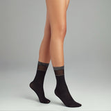 woman wearing black and silver crew socks
