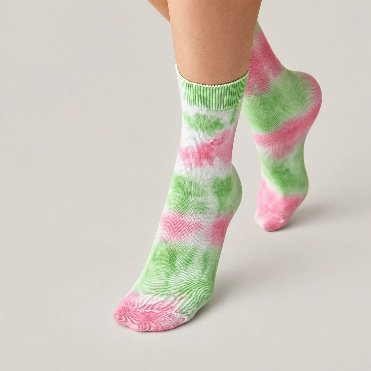 Person wearing washed green and pink crew socks