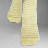 Yellow socks with thin sheer stripes on a grey background