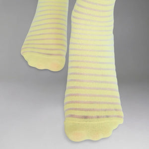 Yellow socks with thin sheer stripes on a grey background