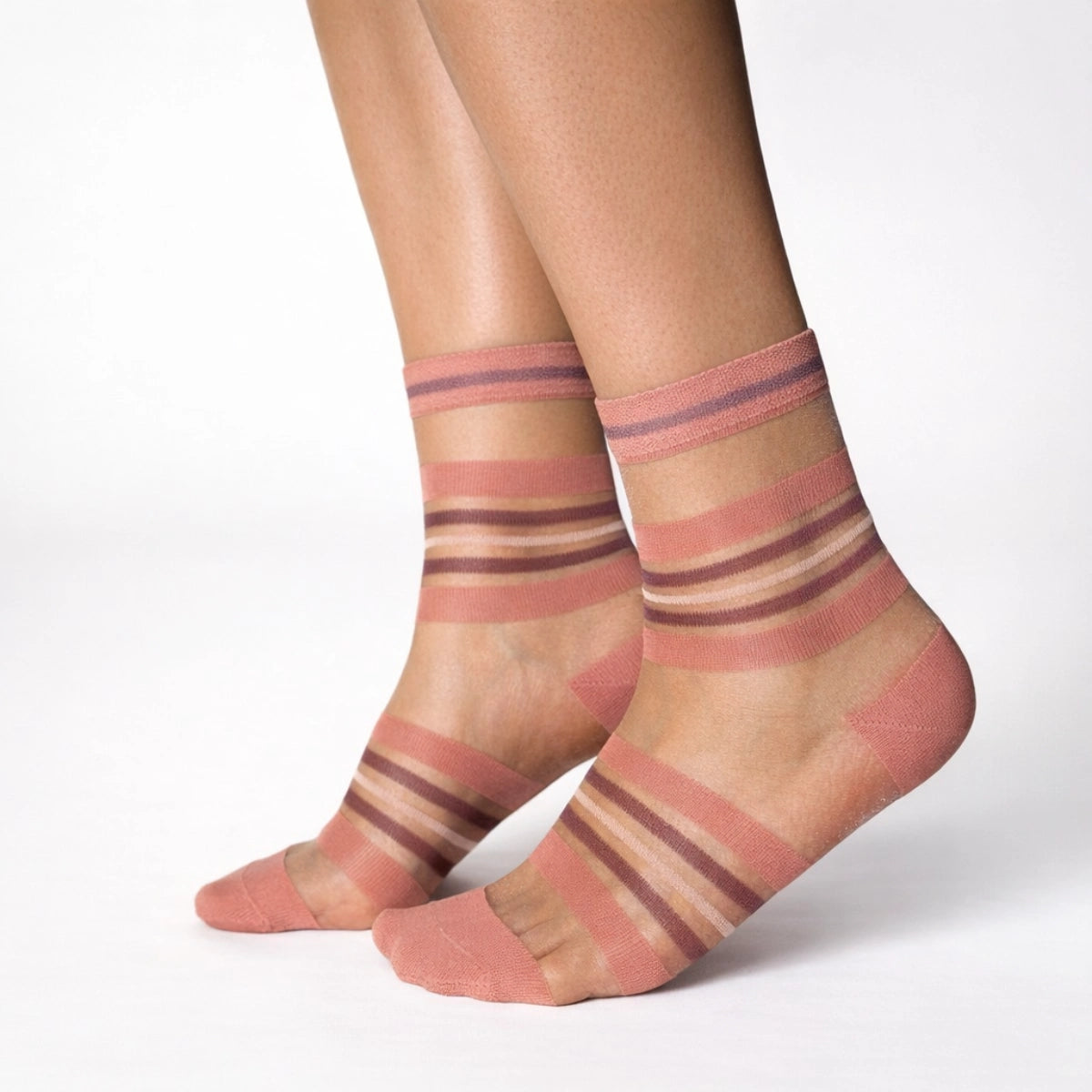 Sheer coral striped socks worn by a person on a white background