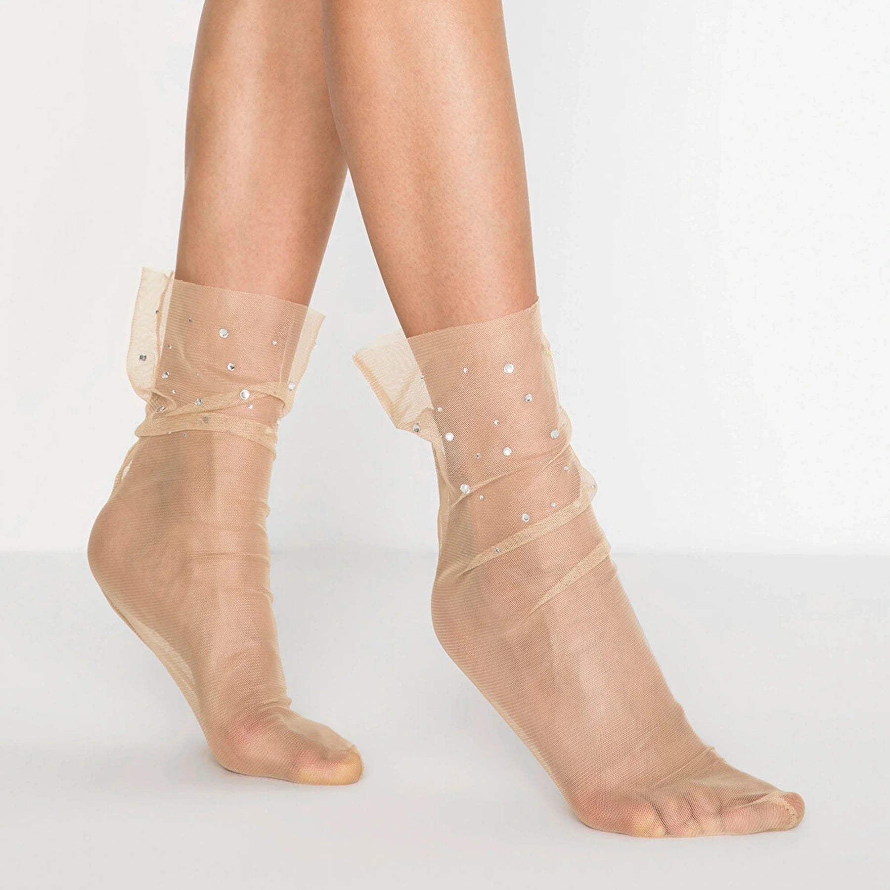 Woman's legs showing loose fitting tule nude socks with small sparkling detail