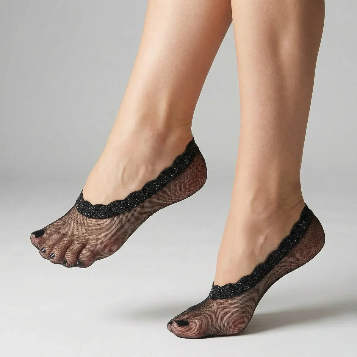 Navy sheer no-show socks with lace trim worn by a person on a neutral background