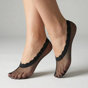 Navy sheer no-show socks with lace trim worn by a person on a neutral background