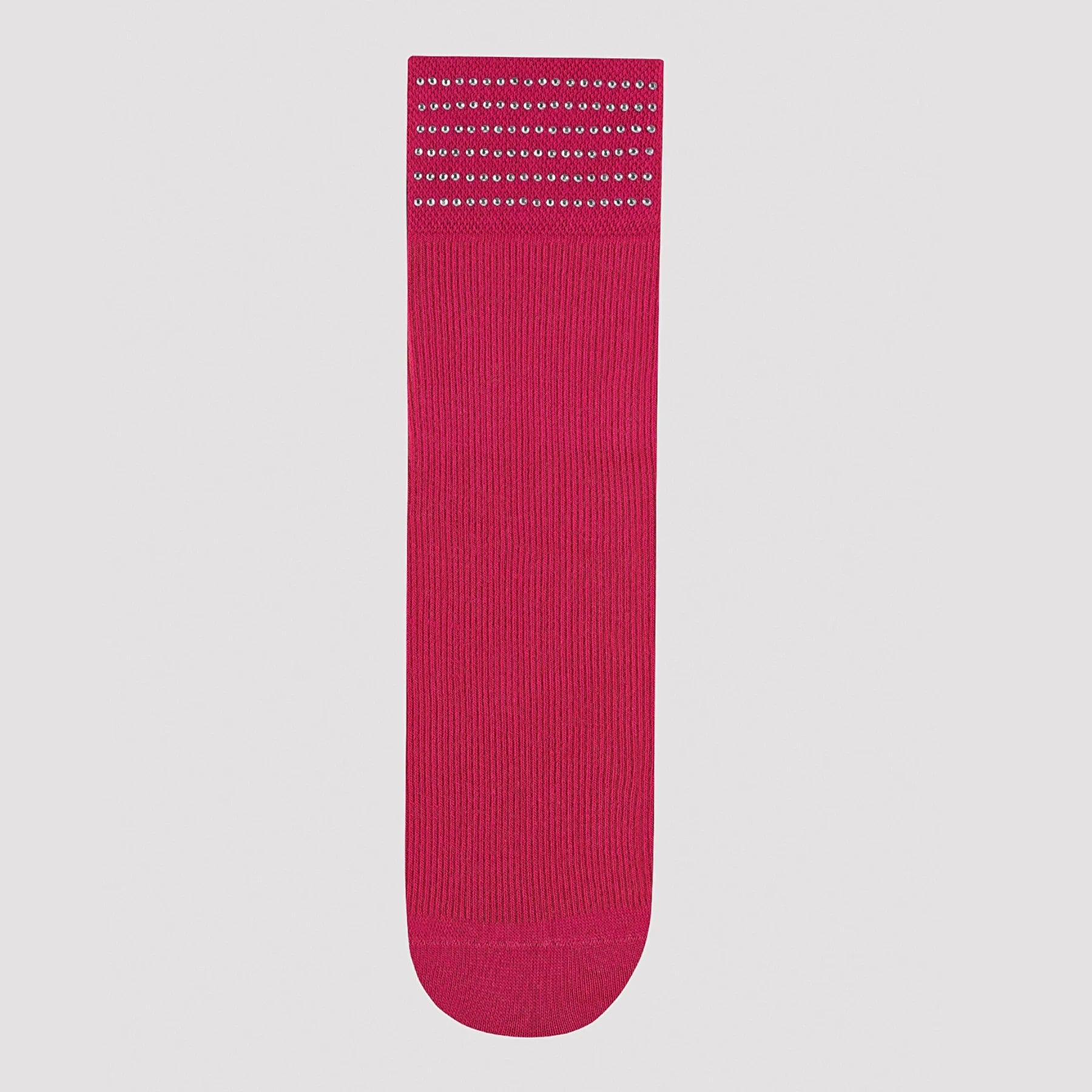 Product shot of  bright pink quarter length sock cuffed with six rows of shiny dots