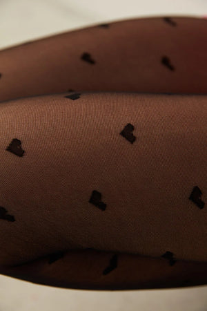 Up close detail of black tights with black love hearts pattern