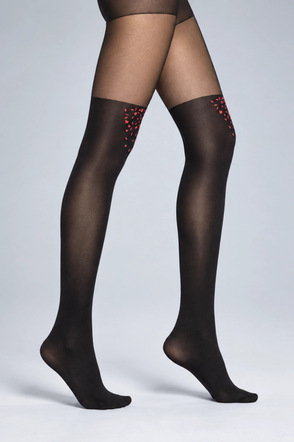 Woman wearing tights shaded darker up to thigh high with red confetti detail