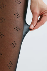 image of woman wearing black dice patterned pantyhose