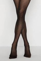 photo of woman's legs wearing black patterned pantyhose