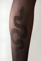 Close-up of black sheer tights featuring a rhinestone snake design on the calf.