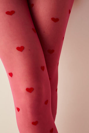 Closeup of fuchsia tights with red love hearts